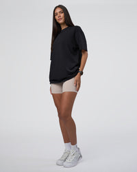 Woman wearing Lifting Club FLXCotton Tee Oversize - Black-Black | Model:Rhiley | Size:XS