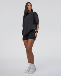 Woman wearing Lifting Club FLXCotton Tee Oversize - Black Washed | Model:Rhiley | Size:XS