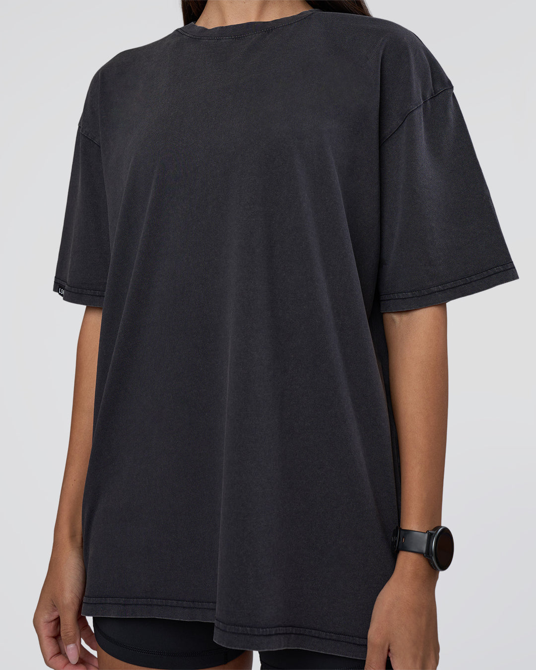 Woman wearing Lifting Club FLXCotton Tee Oversize - Black Washed | Model:Rhiley | Size:XS