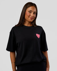 Woman wearing Love the Journey FLXCotton Oversized Tee - Black-Flame | Model:Bianca | Size:XS