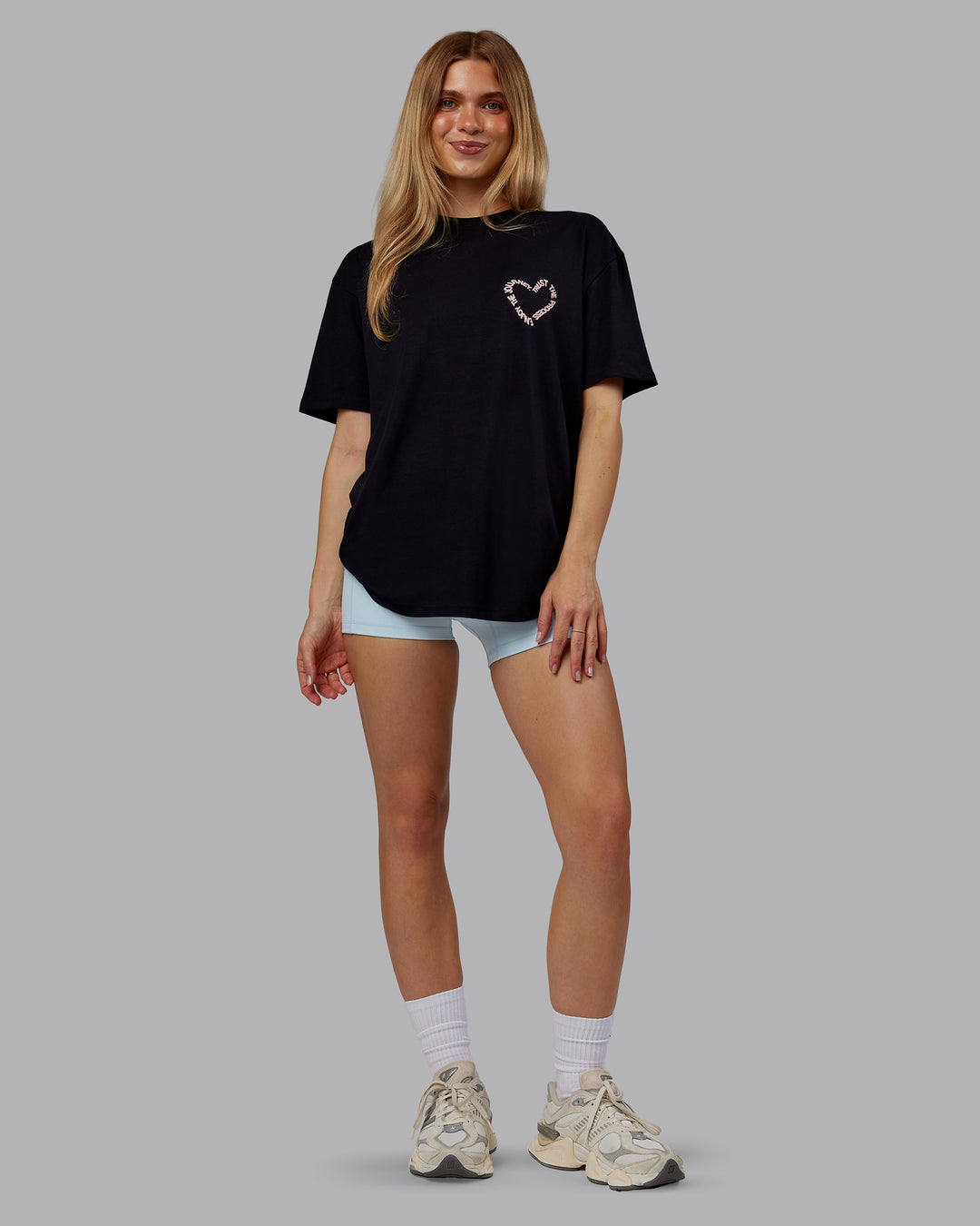 Woman wearing Love The Process FLXCotton Oversize Tee - Black-Peach Fuzz | Model:Emilie | Size:XS