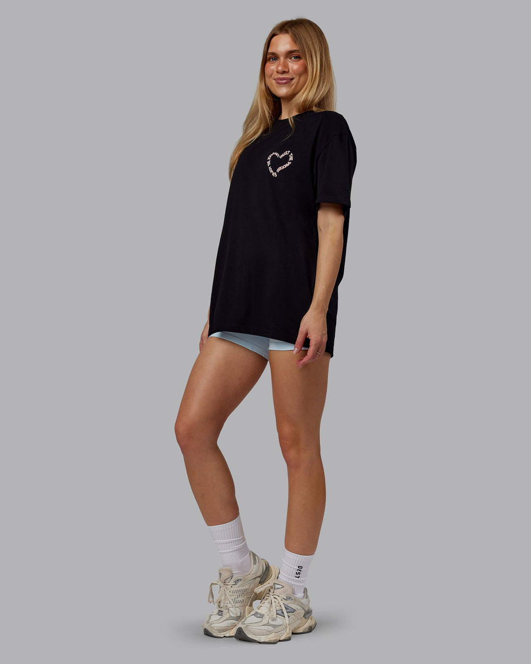 Woman wearing Love The Process FLXCotton Oversize Tee - Black-Peach Fuzz | Model:Emilie | Size:XS