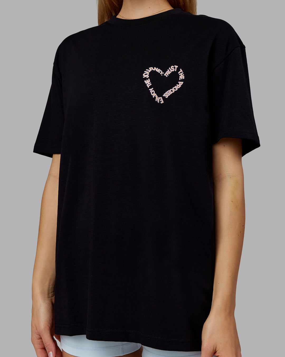 Woman wearing Love The Process FLXCotton Oversize Tee - Black-Peach Fuzz | Model:Emilie | Size:XS