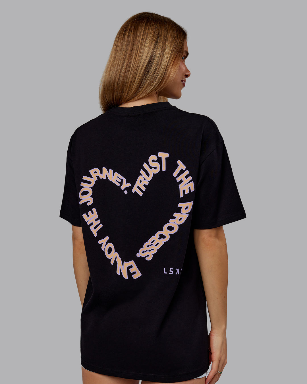 Woman wearing Love The Process FLXCotton Oversize Tee - Black-Peach Fuzz | Model:Emilie | Size:XS