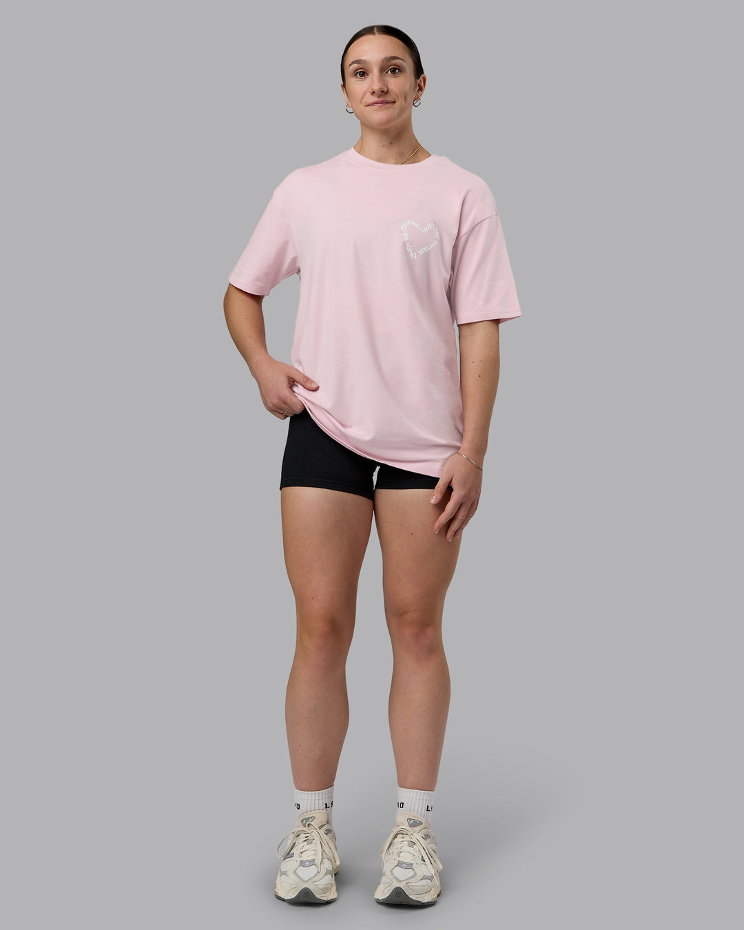 Woman wearing Love The Process FLXCotton Oversize Tee - Petal Pink-White | Model:Sav | Size:XS