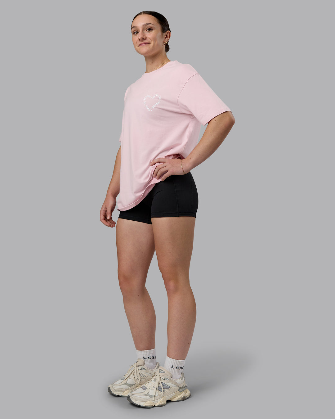 Woman wearing Love The Process FLXCotton Oversize Tee - Petal Pink-White | Model:Sav | Size:XS