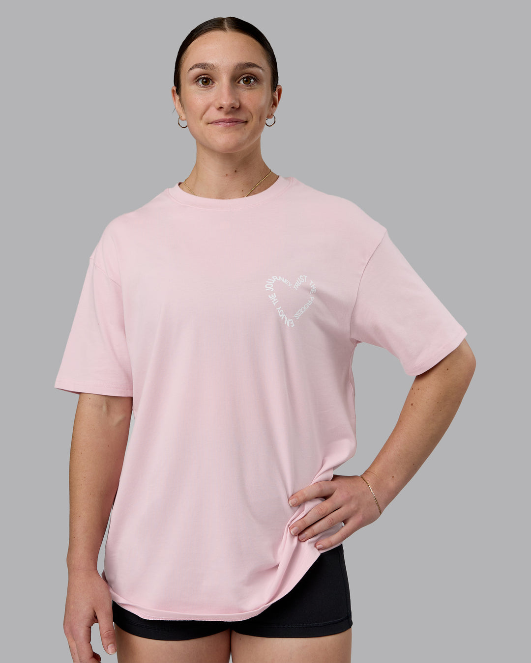 Woman wearing Love The Process FLXCotton Oversize Tee - Petal Pink-White | Model:Sav | Size:XS