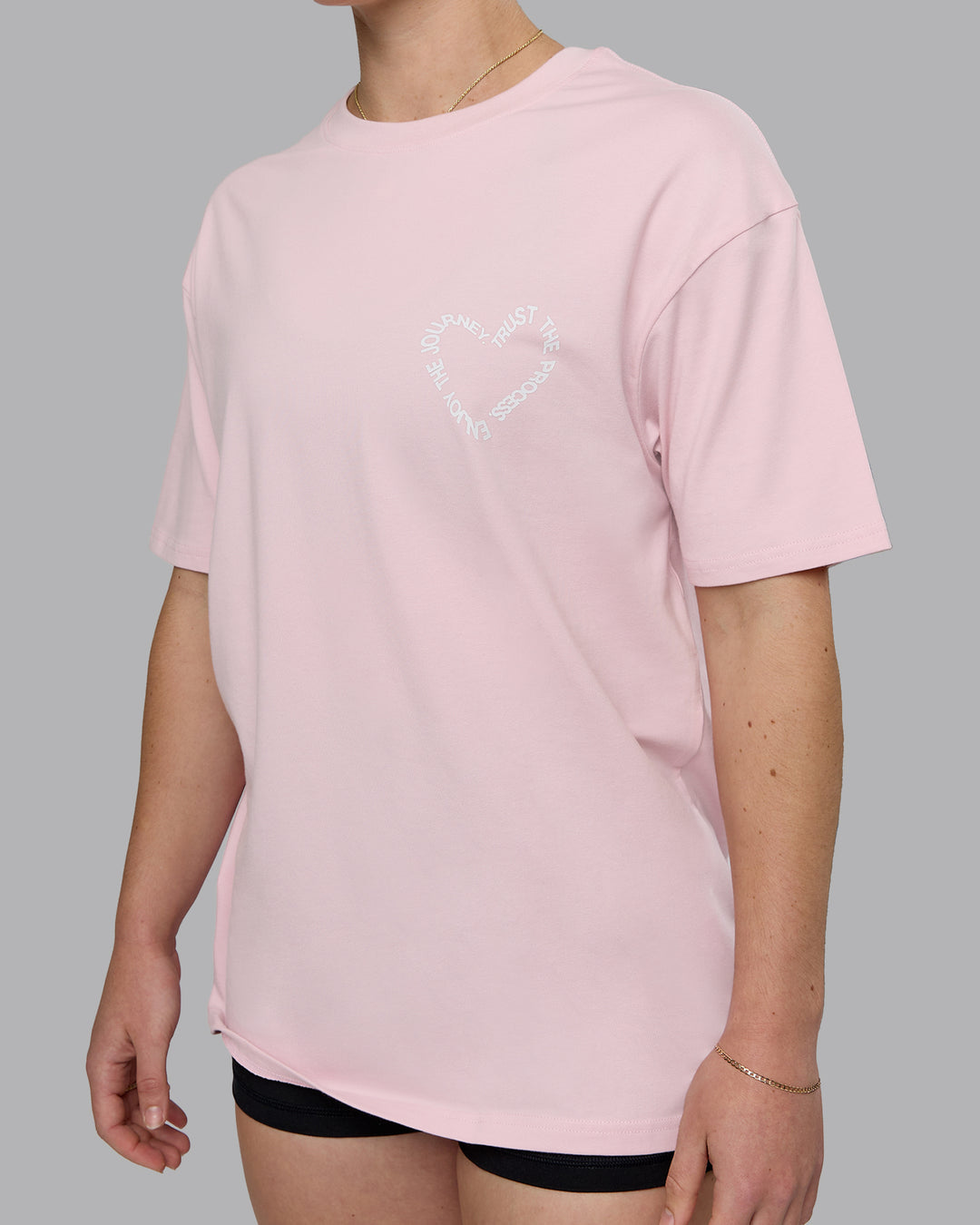 Woman wearing Love The Process FLXCotton Oversize Tee - Petal Pink-White | Model:Sav | Size:XS
