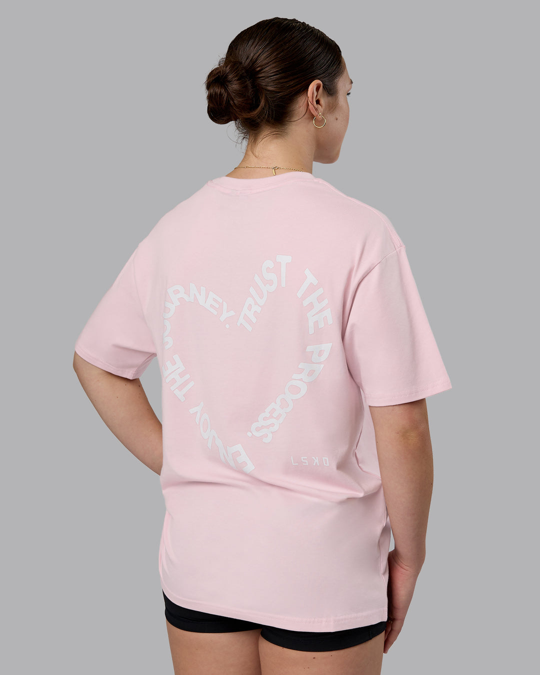 Woman wearing Love The Process FLXCotton Oversize Tee - Petal Pink-White | Model:Sav | Size:XS