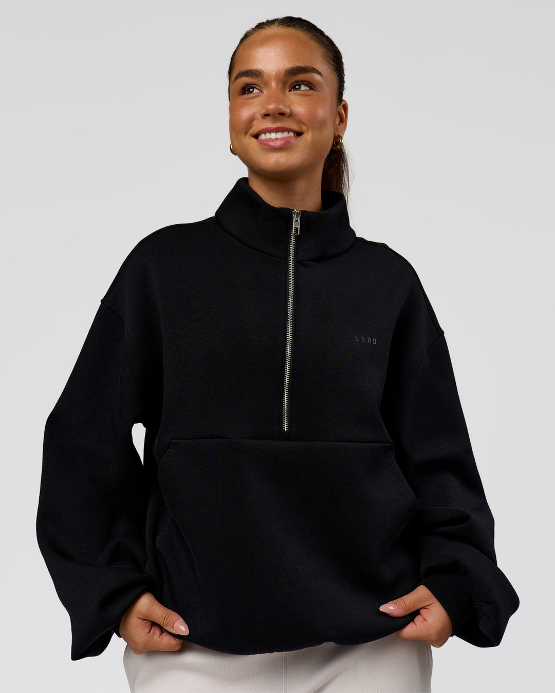 Woman wearing Luxe ZeroCrease Spacer Half Zip - Black | Model:Sophia | Size:XS