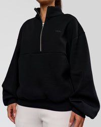 Woman wearing Luxe ZeroCrease Spacer Half Zip - Black | Model:Sophia | Size:XS