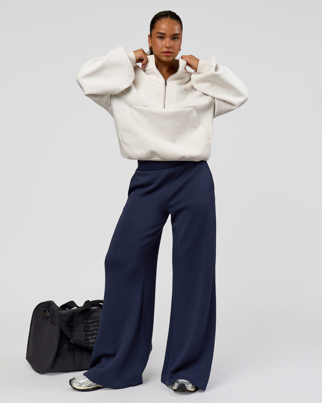 Woman wearing Luxe ZeroCrease Spacer Half Zip - Silver Marl | Model:Sophia | Size:XS