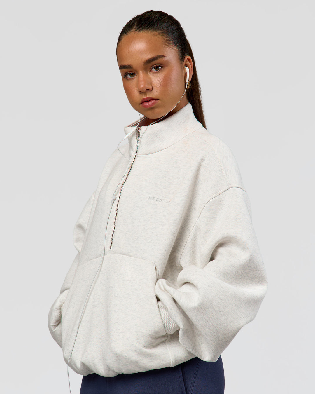 Woman wearing Luxe ZeroCrease Spacer Half Zip - Silver Marl | Model:Sophia | Size:XS