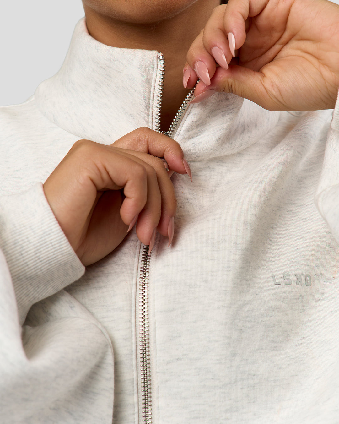Woman wearing Luxe ZeroCrease Spacer Half Zip - Silver Marl | Model:Sophia | Size:XS