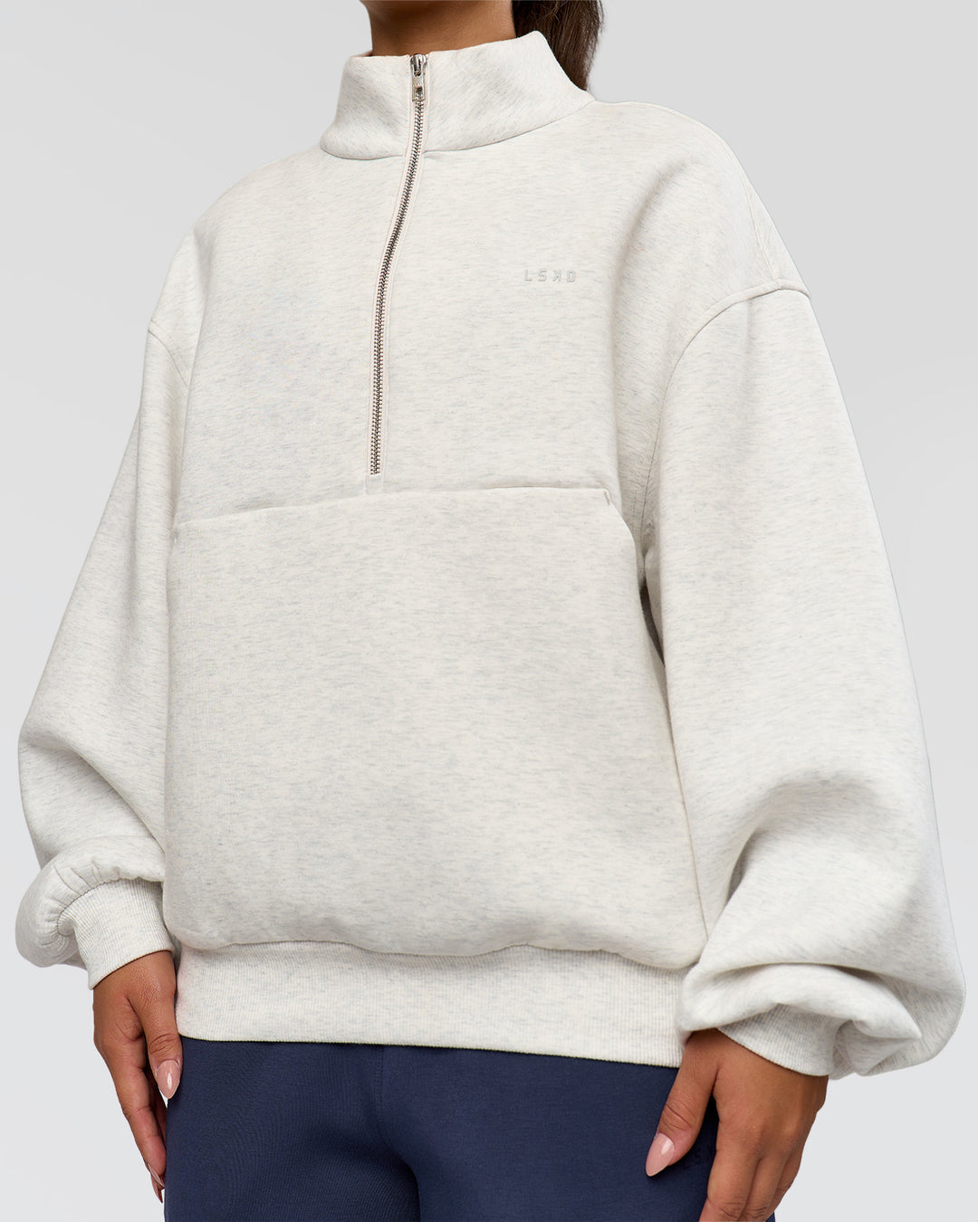 Woman wearing Luxe ZeroCrease Spacer Half Zip - Silver Marl | Model:Sophia | Size:XS