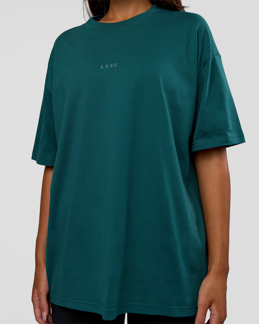 Woman wearing MVP 2.0 Oversized Tee - Transformative Teal | Model:Kirstyn | Size:XS