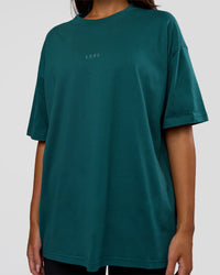 Woman wearing MVP 2.0 Oversized Tee - Transformative Teal | Model:Kirstyn | Size:XS
