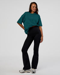 Woman wearing MVP 2.0 Oversized Tee - Transformative Teal | Model:Kirstyn | Size:XS