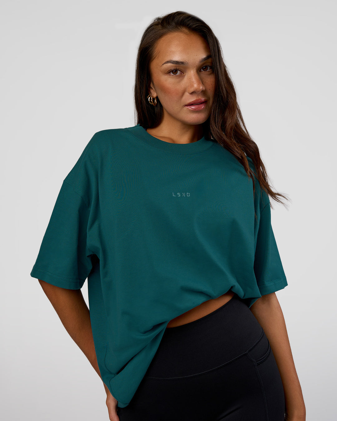 Woman wearing MVP 2.0 Oversized Tee - Transformative Teal | Model:Kirstyn | Size:XS