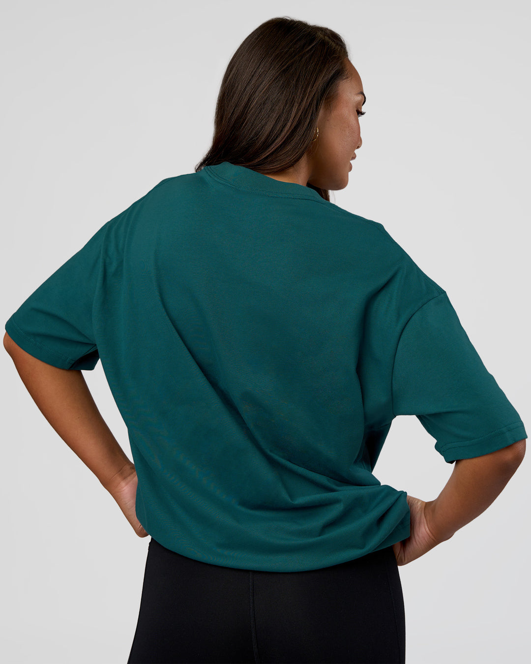 Woman wearing MVP 2.0 Oversized Tee - Transformative Teal | Model:Kirstyn | Size:XS