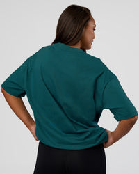 Woman wearing MVP 2.0 Oversized Tee - Transformative Teal | Model:Kirstyn | Size:XS