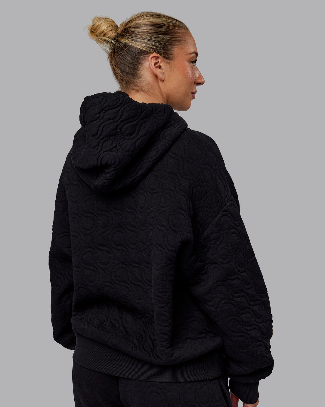 Woman wearing MVP Quilted Oversized Hoodie - Black-Geometric | Model:Lyss | Size:XS