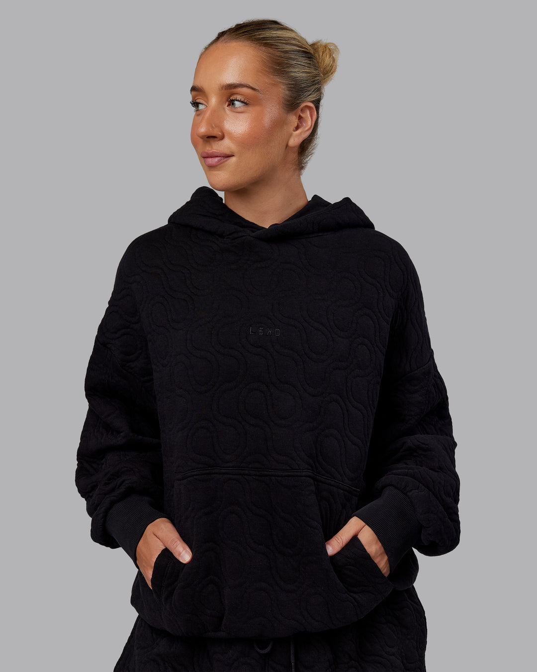 Woman wearing MVP Quilted Oversized Hoodie - Black-Geometric | Model:Lyss | Size:XS