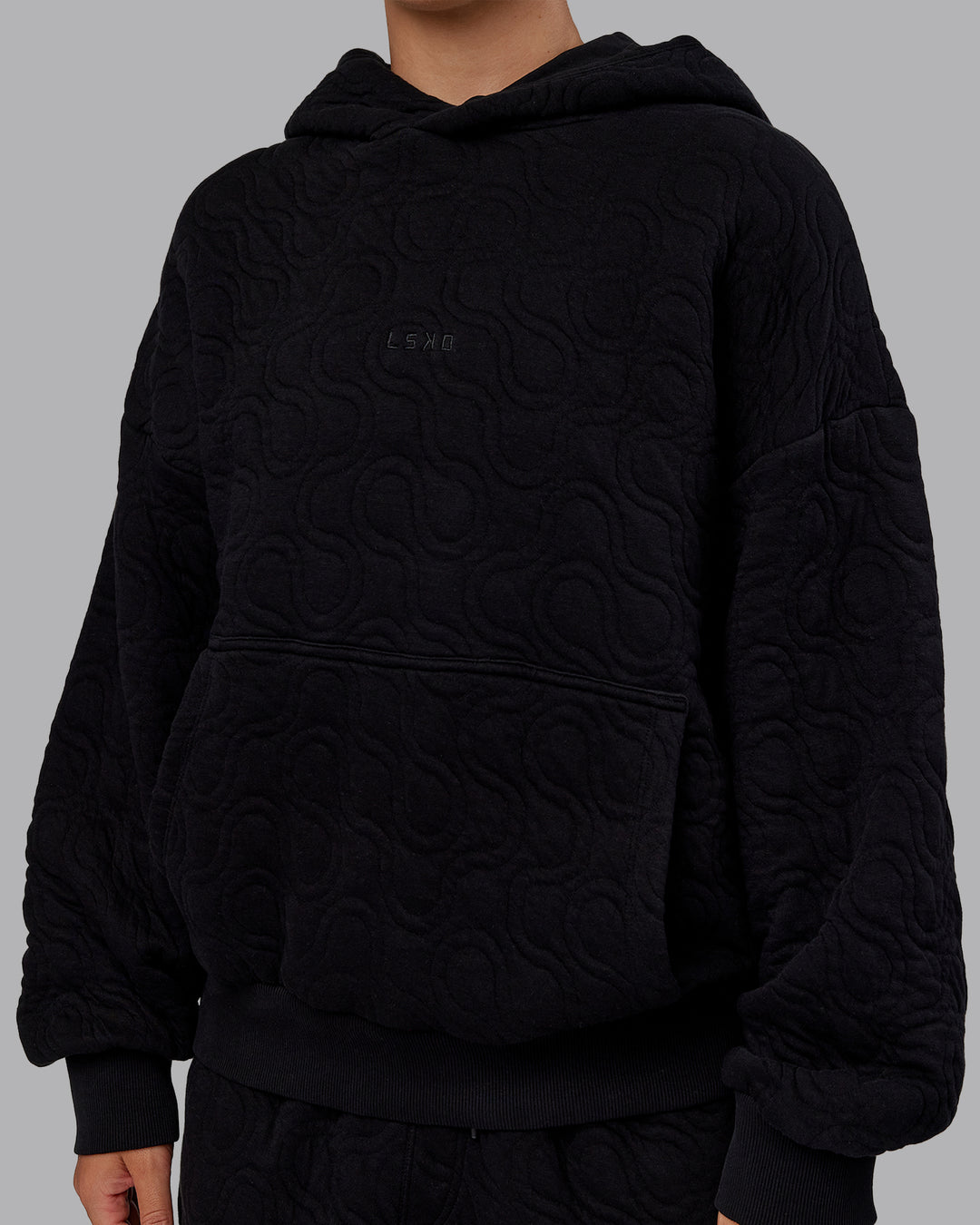 Woman wearing MVP Quilted Oversized Hoodie - Black-Geometric | Model:Lyss | Size:XS