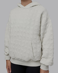 Woman wearing MVP Quilted Oversized Hoodie - Digital Mist-Geometric | Model:Lyss | Size:XS