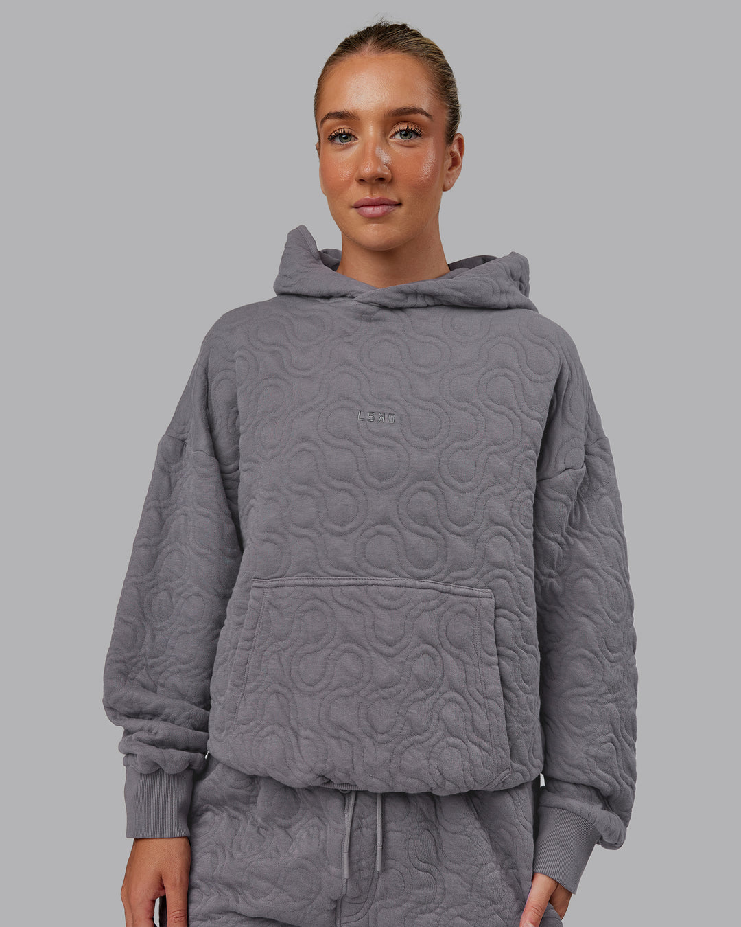 Woman wearing MVP Quilted Oversized Hoodie - Storm Front-Geometric | Model:Lyss | Size:XS
