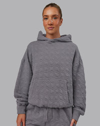 Woman wearing MVP Quilted Oversized Hoodie - Storm Front-Geometric | Model:Lyss | Size:XS