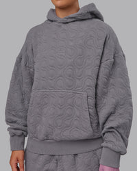 Woman wearing MVP Quilted Oversized Hoodie - Storm Front-Geometric | Model:Lyss | Size:XS