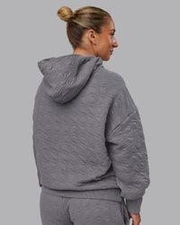Woman wearing MVP Quilted Oversized Hoodie - Storm Front-Geometric | Model:Lyss | Size:XS