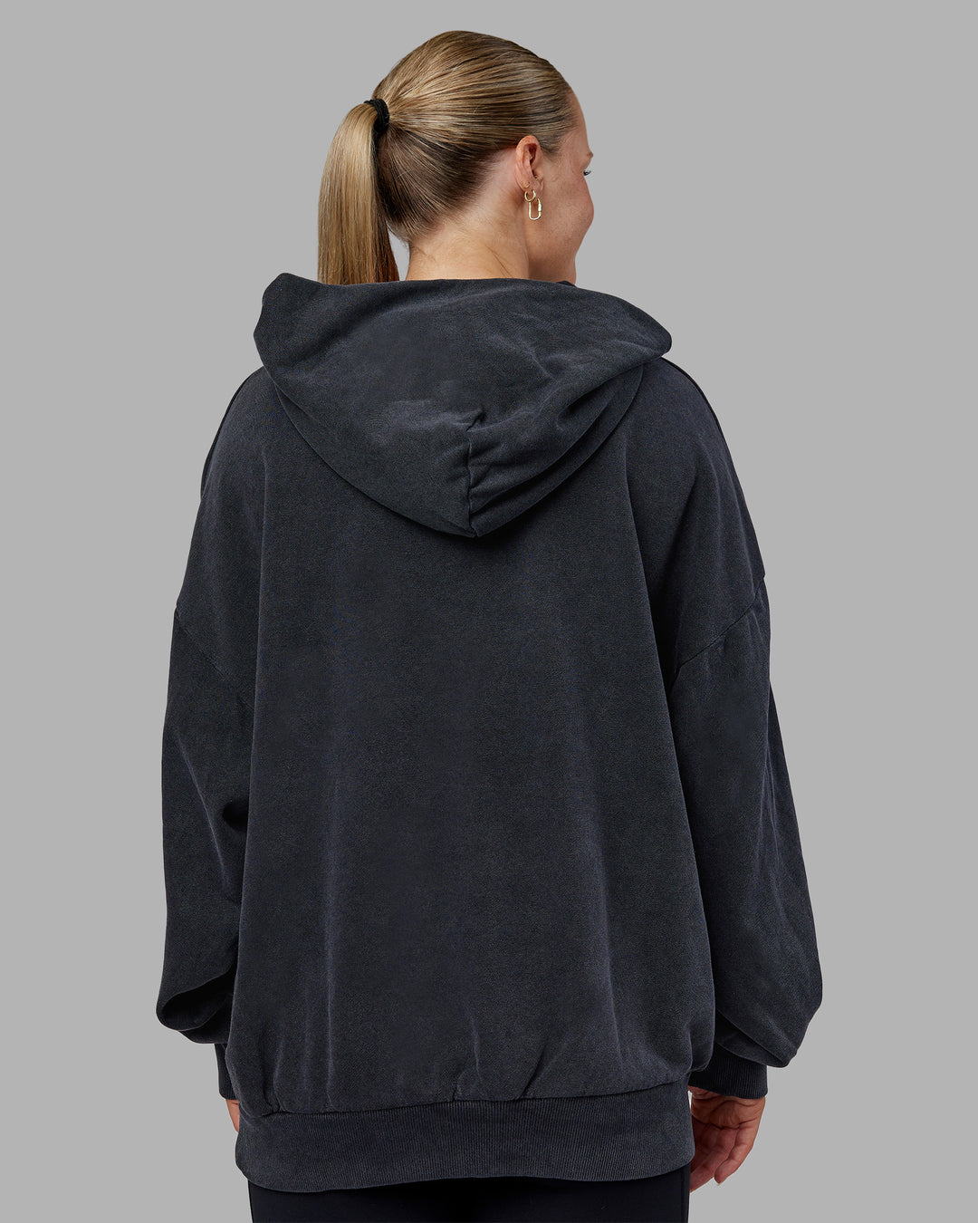 Woman wearing MVP Washed Terry Oversized Hoodie - Black Washed | Model:Neve | Size:XS