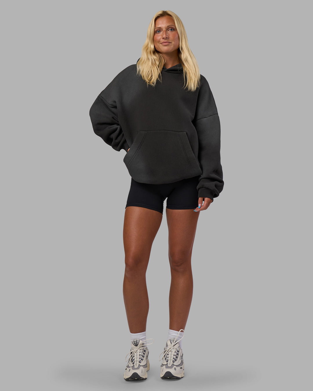 Woman wearing Memory In Motion 500gsm Ultra Heavyweight Washed Hoodie - Charcoal Washed | Model:Alex | Size:XS