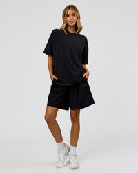 Woman wearing Memory in Motion Heavyweight Oversized Tee - Black Washed | Model:Leilani | Size:XS