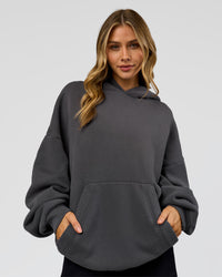 Woman wearing Memory In Motion Ultra Heavyweight Washed Hoodie - Dark Storm Washed | Model:Leilani | Size:XS