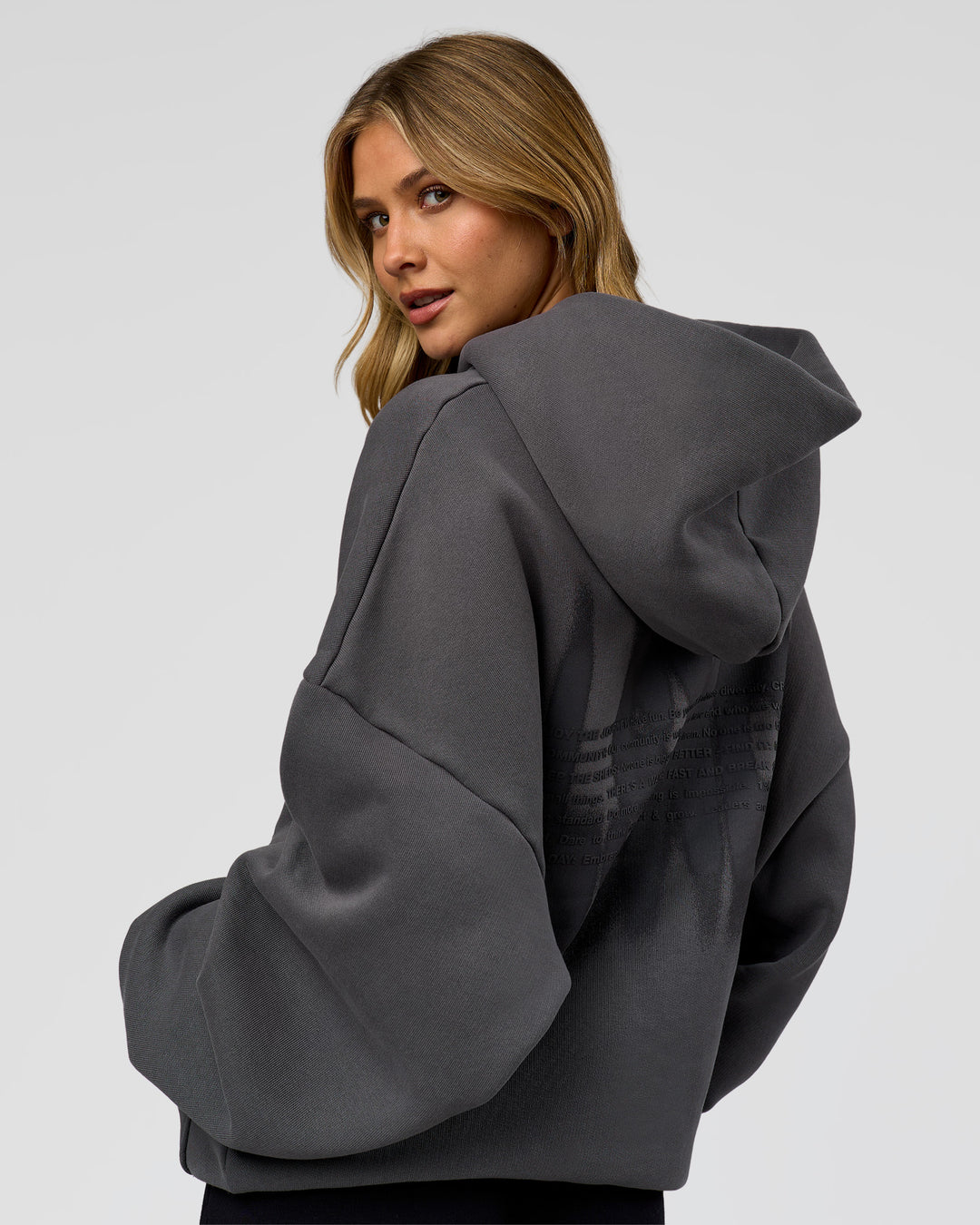 Woman wearing Memory In Motion Ultra Heavyweight Washed Hoodie - Dark Storm Washed | Model:Leilani | Size:XS
