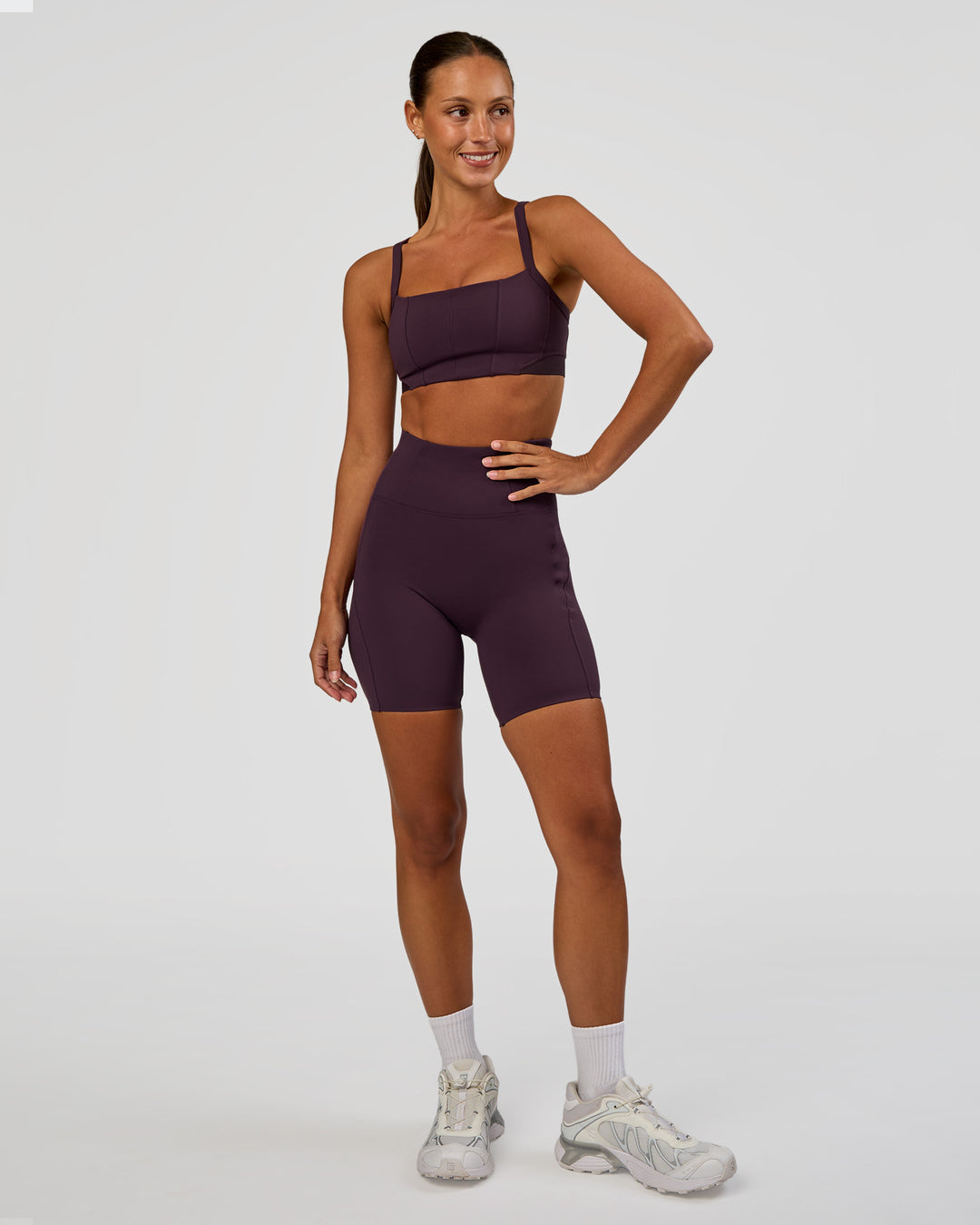 Woman wearing Momentum Corset Sports Bra - Midnight Plum | Model:Brylee | Size:XS
