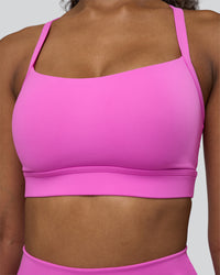 Woman wearing Momentum Sports Bra D/DD/E - Ultra Fuchsia | Model:Jordan | Size:XS