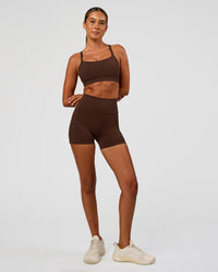 Woman wearing Momentum Sports Bra - Hot Chocolate | Model:Charli | Size:XS
