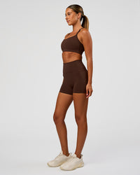Woman wearing Momentum Sports Bra - Hot Chocolate | Model:Charli | Size:XS