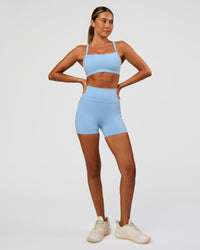 Woman wearing Momentum Sports Bra - Open Air | Model:Charli | Size:XS