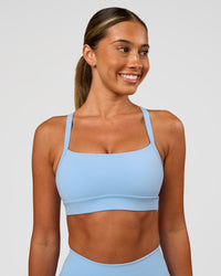 Woman wearing Momentum Sports Bra - Open Air | Model:Charli | Size:XS