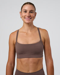 Woman wearing Momentum Sports Bra - Peppercorn | Model:Peppercorn | Size:XS