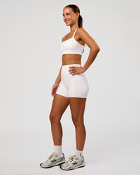 Woman wearing Momentum Sports Bra - White | Model:Brylee | Size:XS