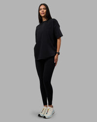 Woman wearing Move Fast Washed Heavyweight Tee Oversize - Black-Island Paradise | Model:Rhiley | Size:XS