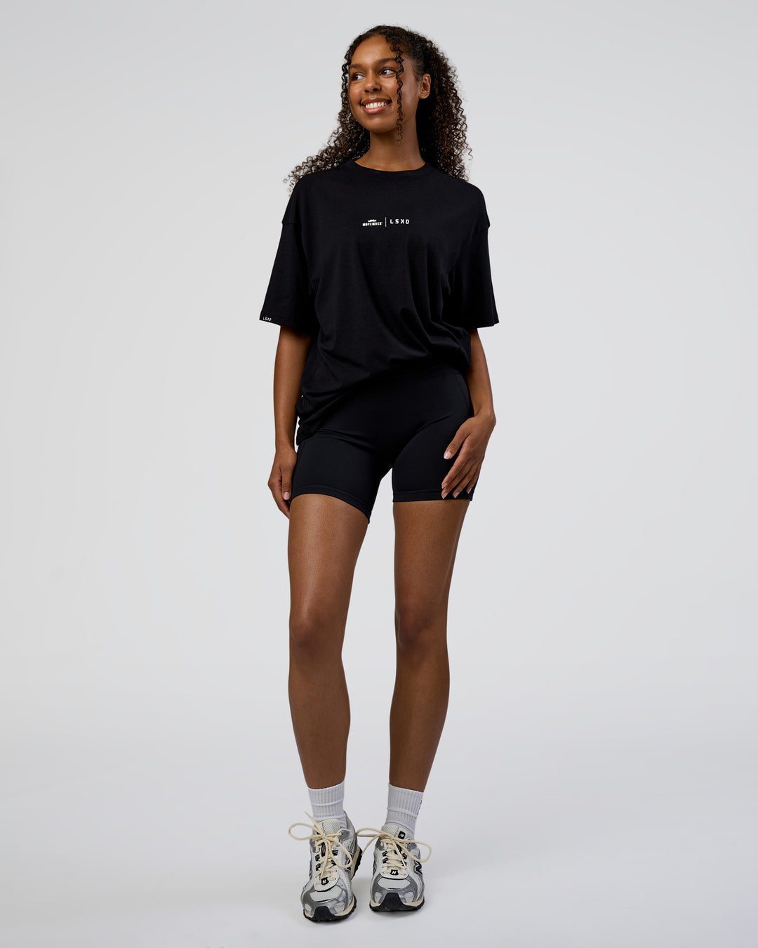 Woman wearing Movember 2025 FLXCotton Oversize Tee - Black | Model:Jordan | Size:XS