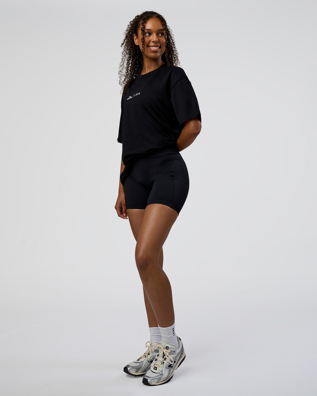 Woman wearing Movember 2025 FLXCotton Oversize Tee - Black | Model:Jordan | Size:XS