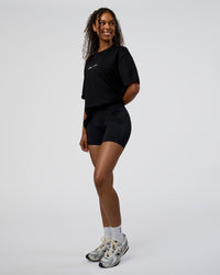 Woman wearing Movember 2025 FLXCotton Oversize Tee - Black | Model:Jordan | Size:XS